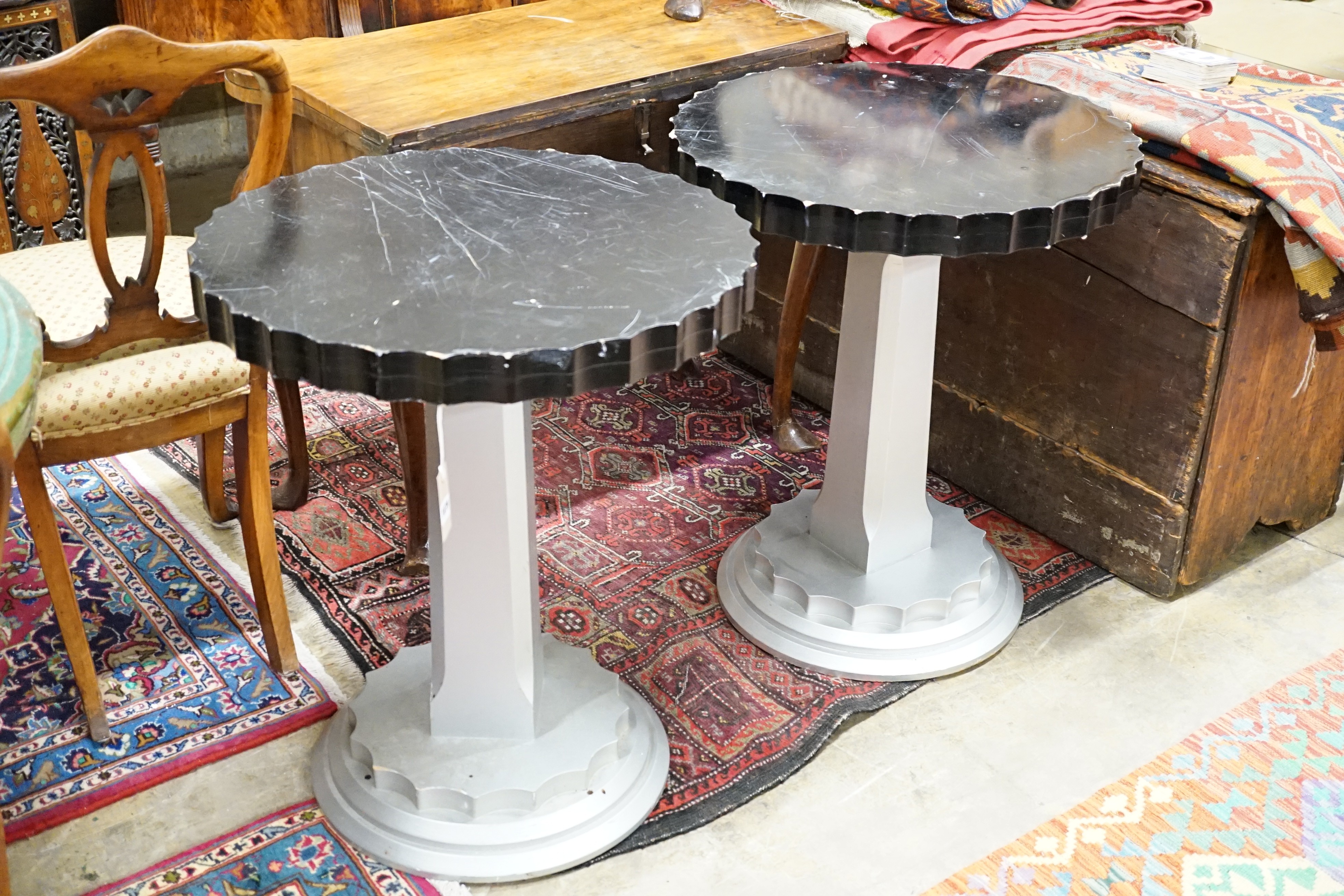 A pair of Art Deco ebonised and silvered wood occasional tables, diameter 60cm, height 71cm
